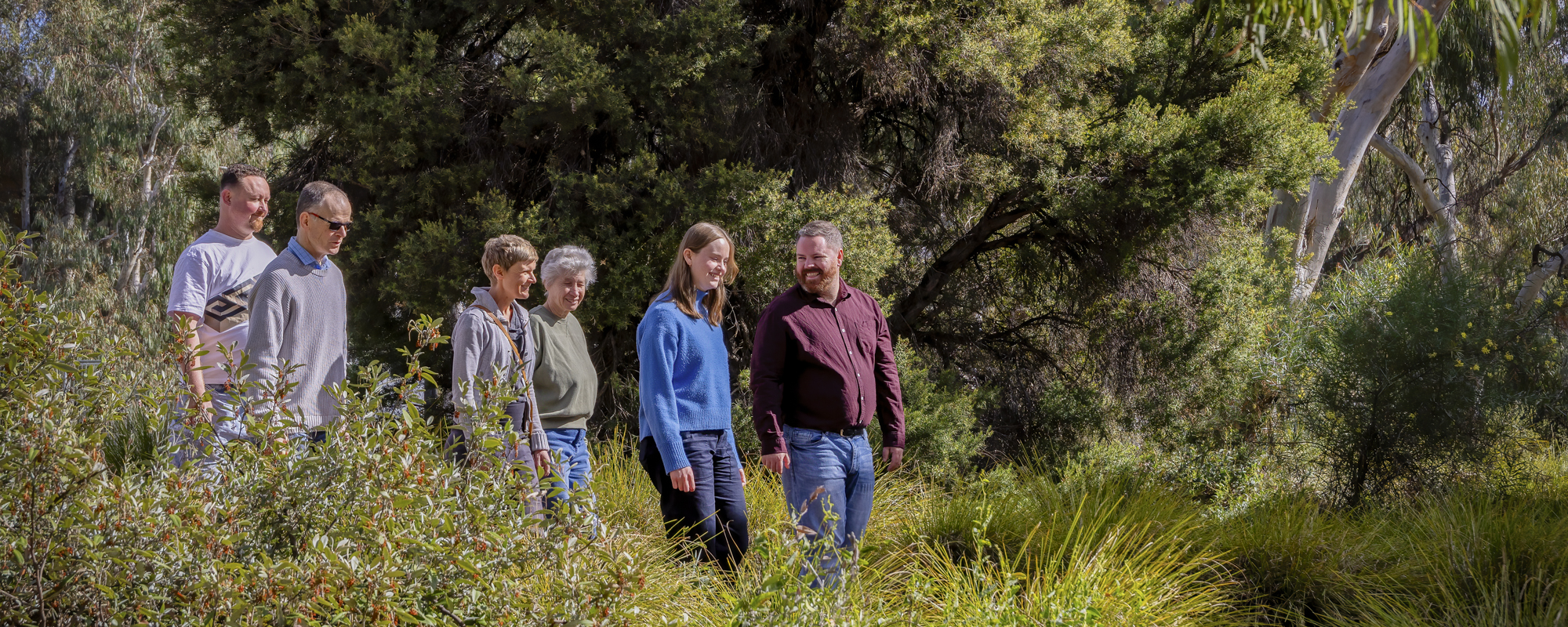 Photo by H. Murray Conservation Council team and volunteers walking through native vegetation.